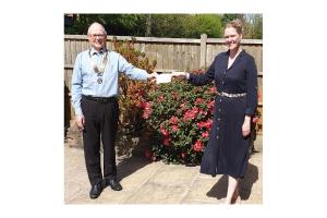 President Robin Carter hands over the donation to Karen Brady